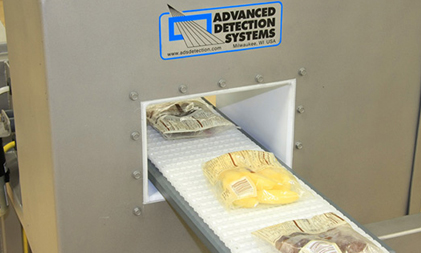 Packaged Food Going through Food Industry Metal Detector