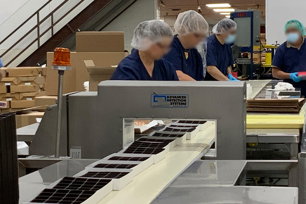 Conveyor metal detector in use in a commercial bakery